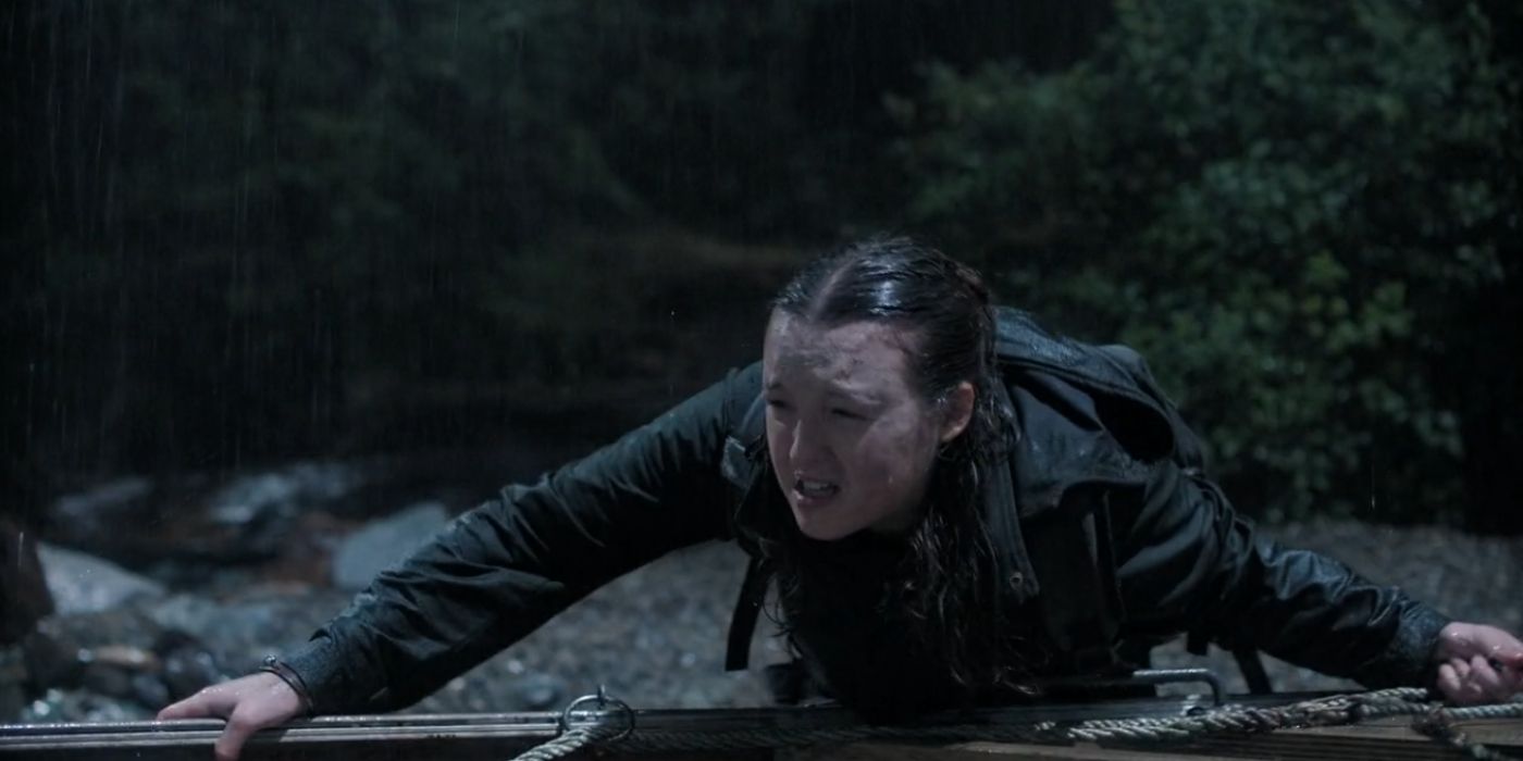 Ellie pushing a boat to escape Seraphite Island in The Last of Us episode "Convergence"