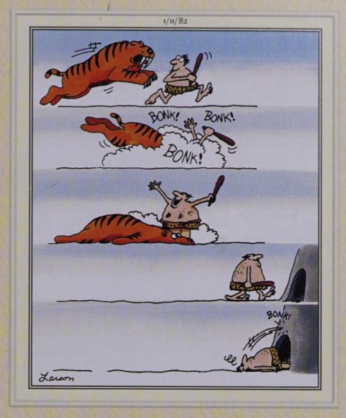 A caveman runs from a Sabretooth