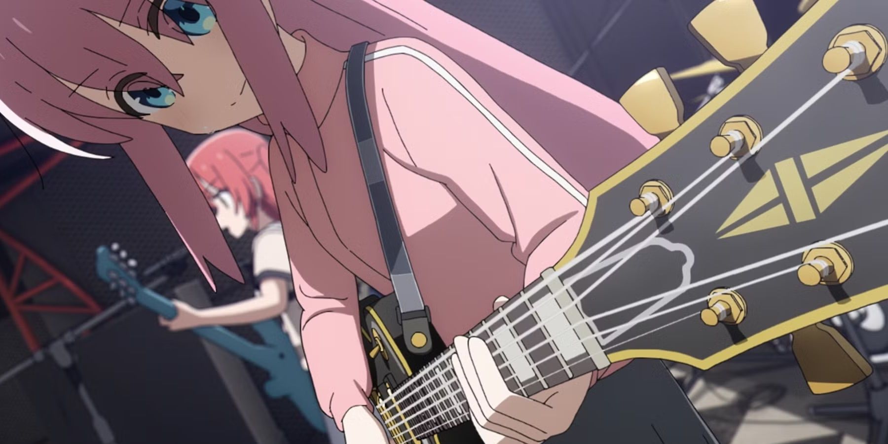 Hitori Gotoh playing guitar onstage.