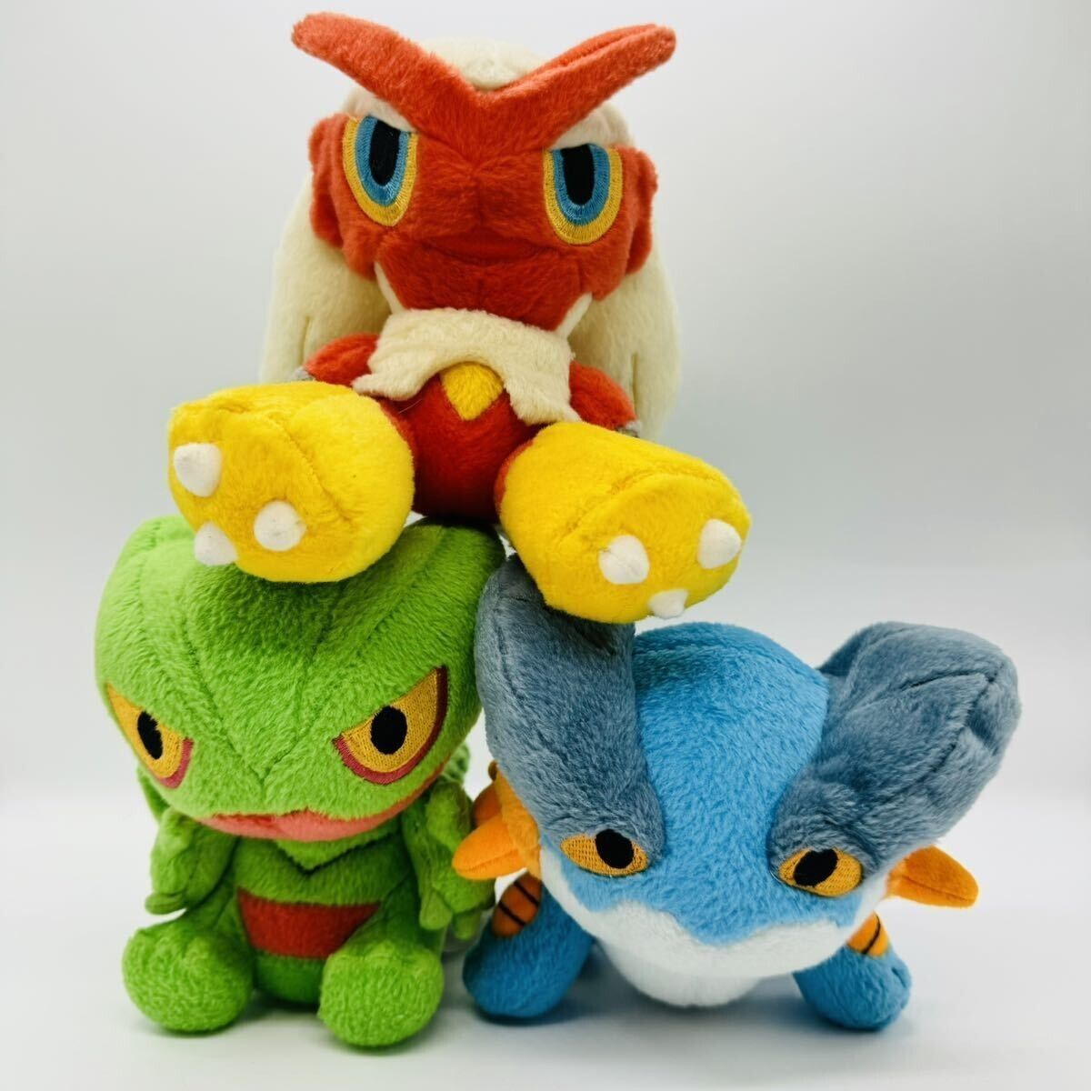 Blaziken, skeptile and Swampert Pokémon dolls.