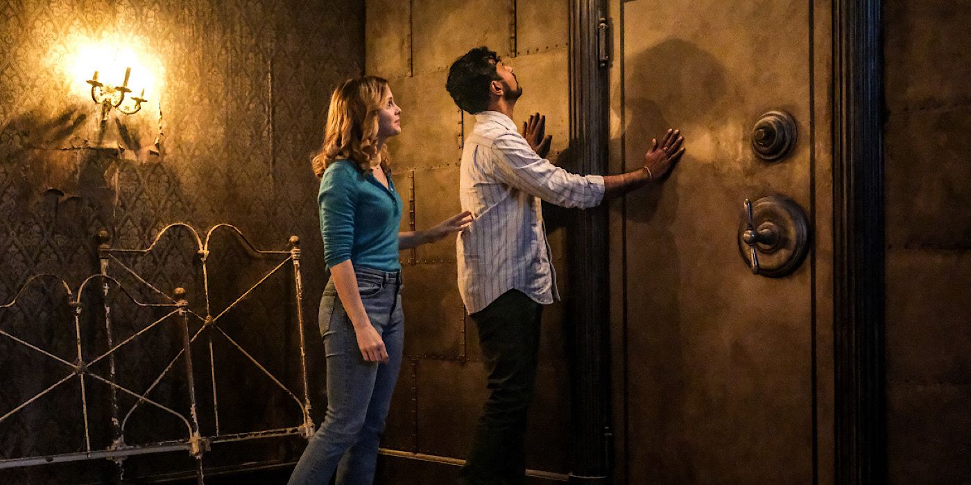 Ghosts - Sam stands behind Jay as he knocks on the vault door.