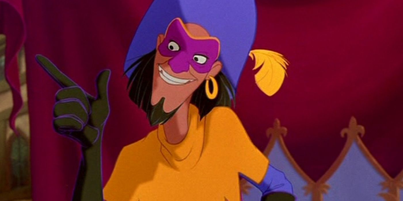 Clopin wears a mask and hat and points a finger.