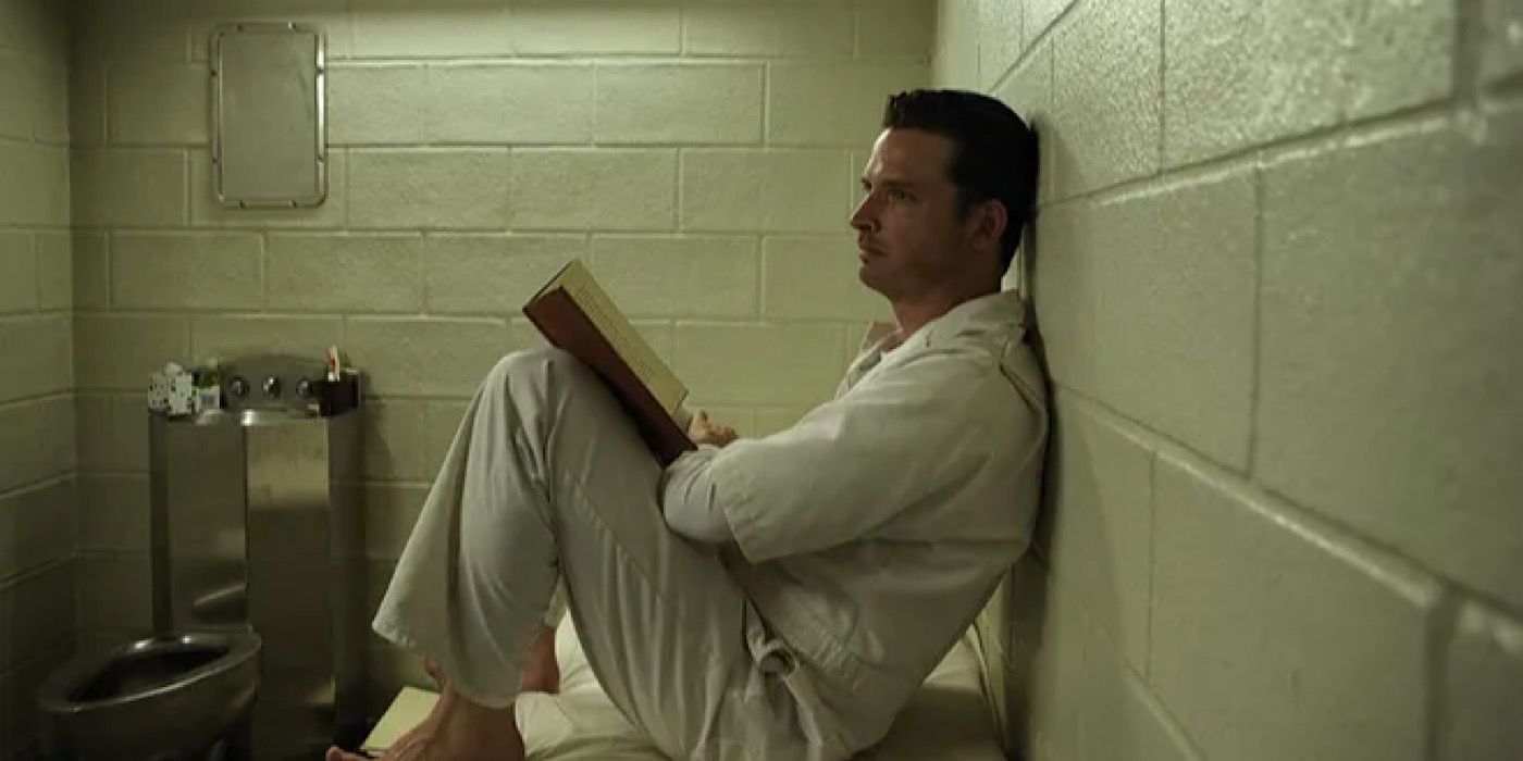 Daniel Holden está sentado en su cama leyendo en su celda de prisión.