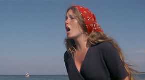 A woman standing on the beach screaming in Jaws