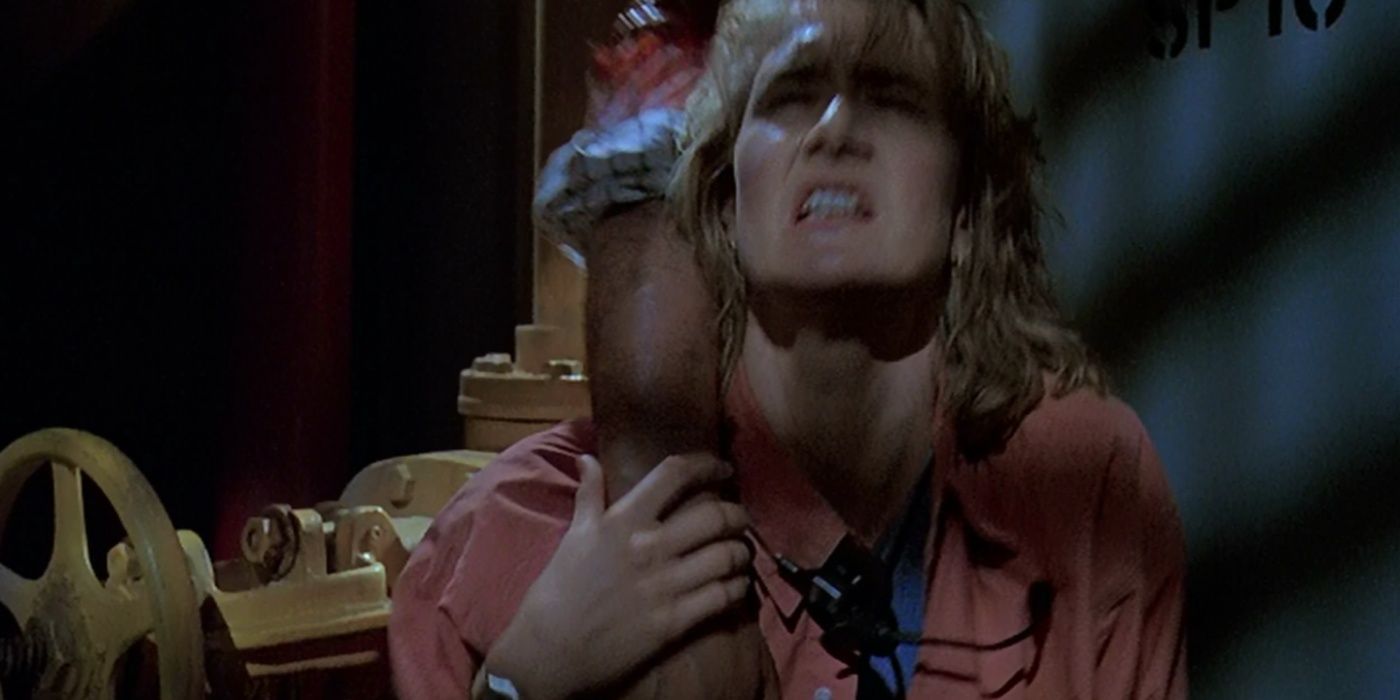 An exhausted Ellie Sattler unknowingly holds the severed arm of Ray Arnold in Jurassic Park.