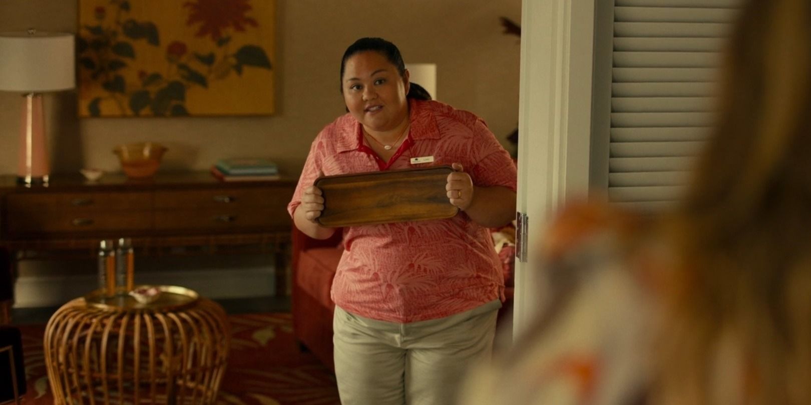 Lani (Jolene Purdy) assists a guest in the White Lotus Pilot