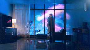 Superman and Lois hugging in an apartment as brightly colored power blasts shine outside it from Superman 2025