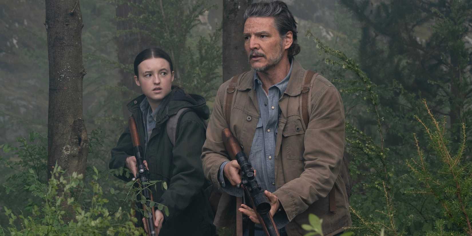 Joel Miller (Pedro Pascal) and Ellie Williams (Bella Ramsey) walking through the woods on The Last of Us