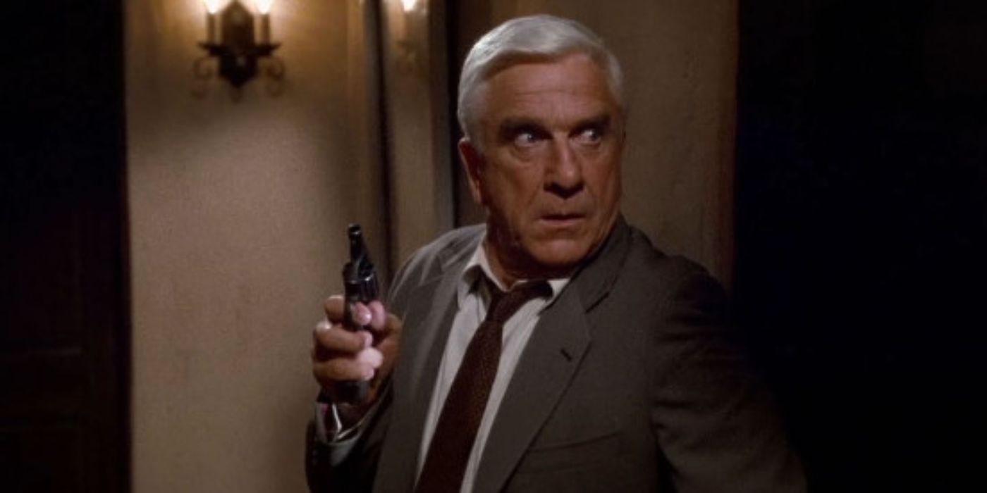 Leslie Nielsen as Frank Drebin holding a gun from the movie The Naked Gun: From the Files of Police Squad! (1988)