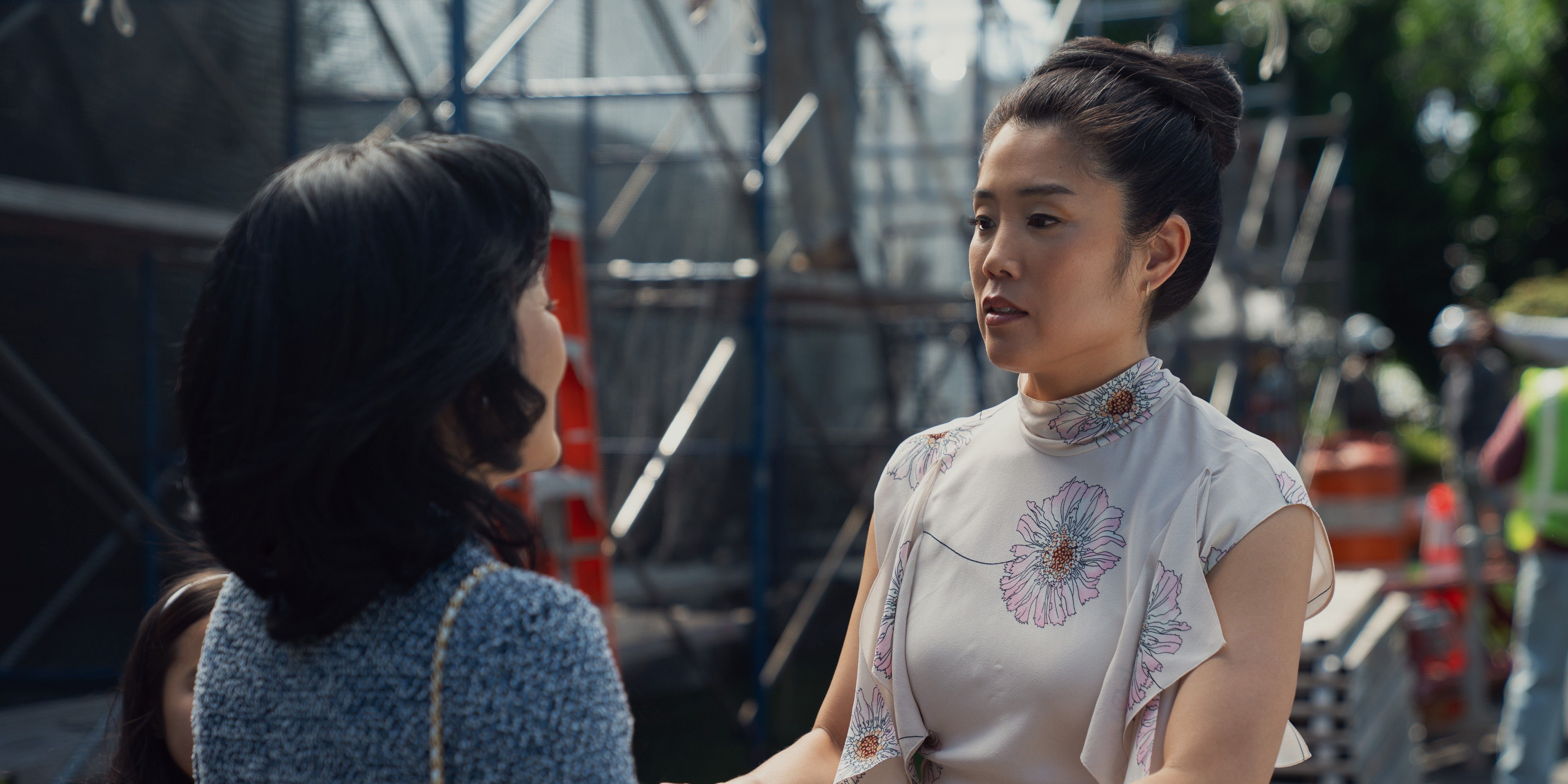 Grace, wearing a gray blouse, faces her mom, who wears a blue sweater, in your friends and neighbors