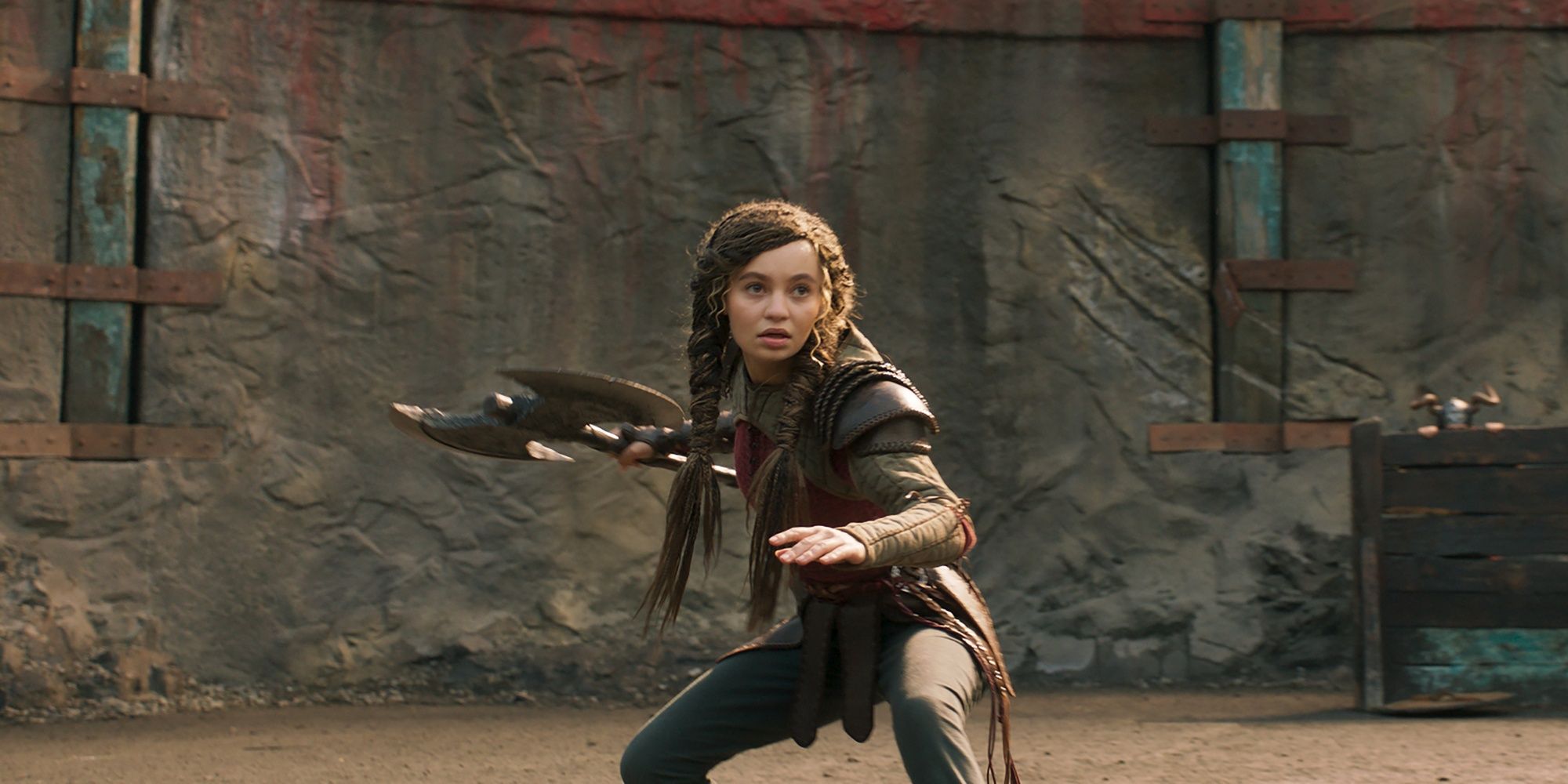 Astrid holding an ax and preparing to fight in how to train your dragon