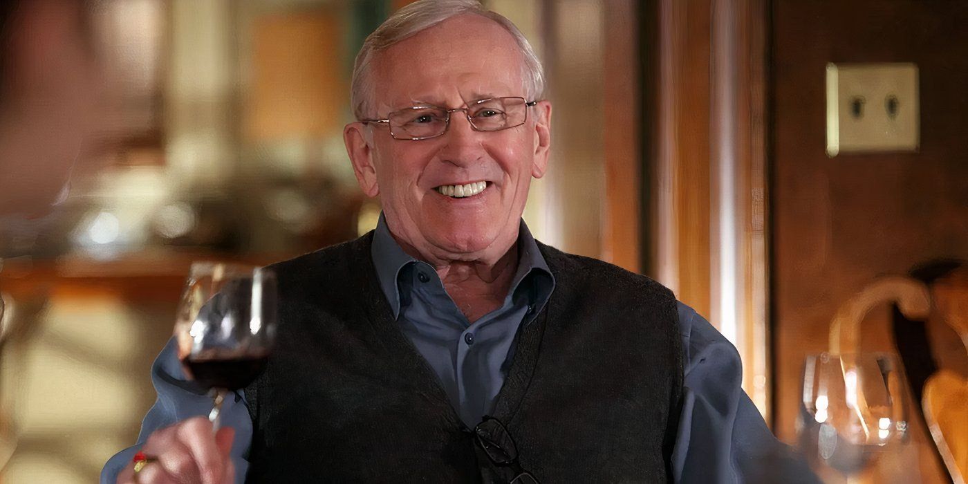 Henry Reagan smiling and holding a glass of wine in Blue Bloods