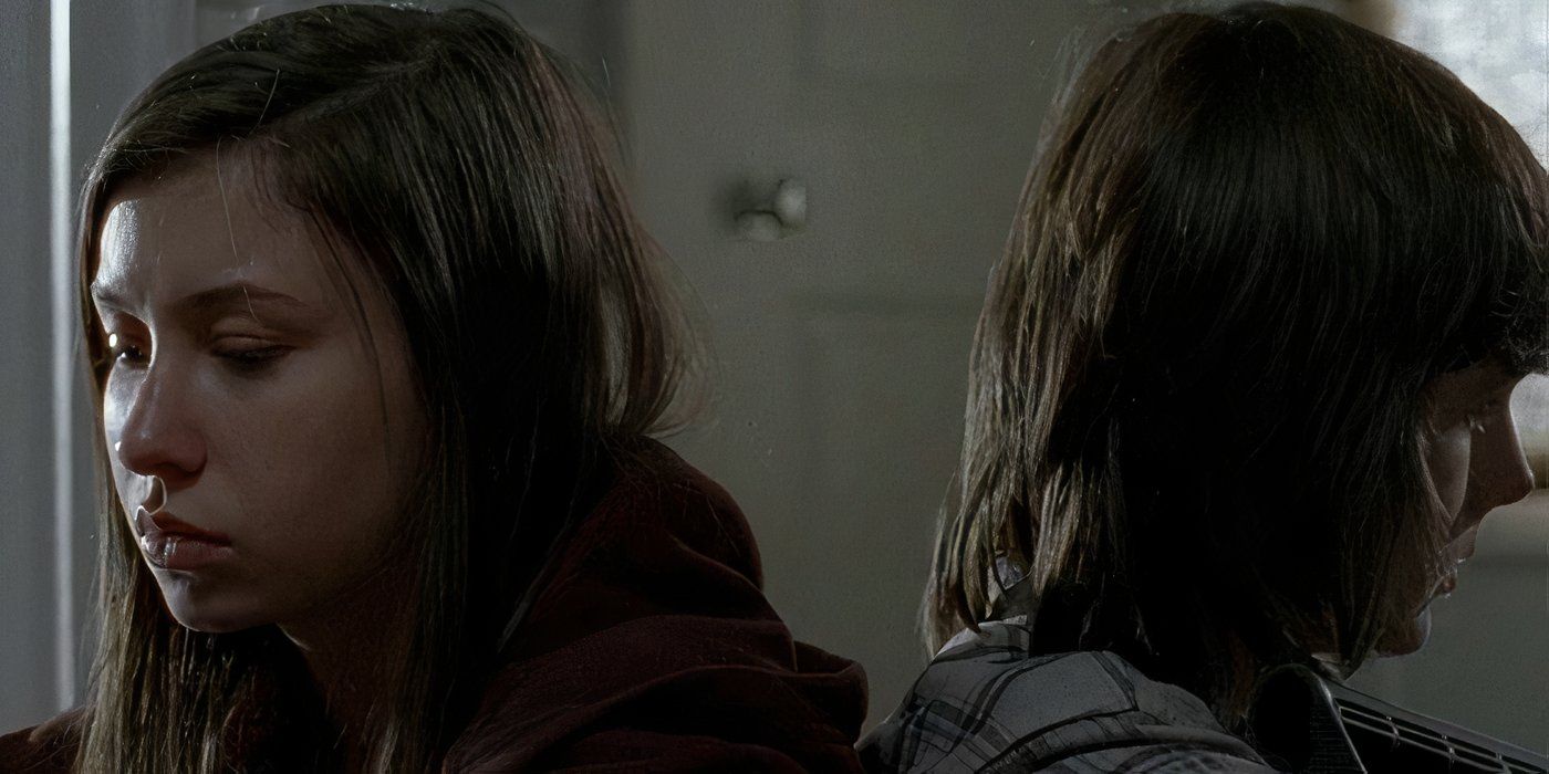 Carl and Enid sit back to back in a scene from The Walking Dead.