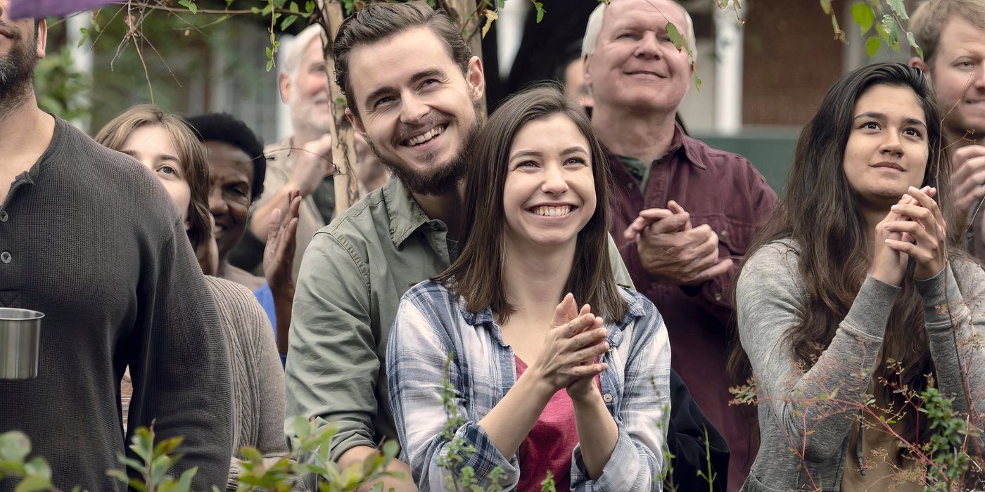 Enid and Alden smile together in a scene from The Walking Dead.