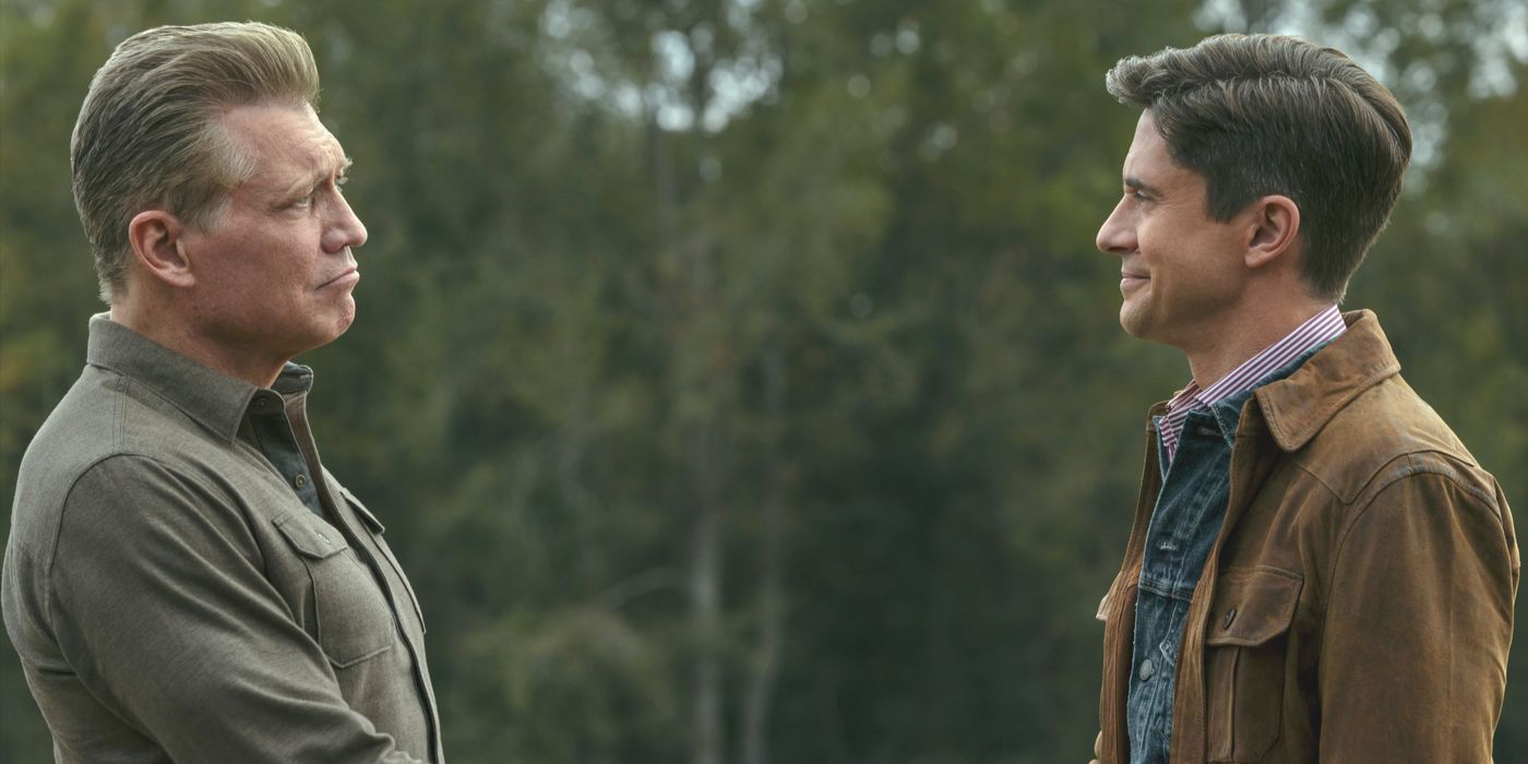 Harlan, in an olive shirt, shakes hands with Grady (Topher Grace) in brown jacket in The Waterfront