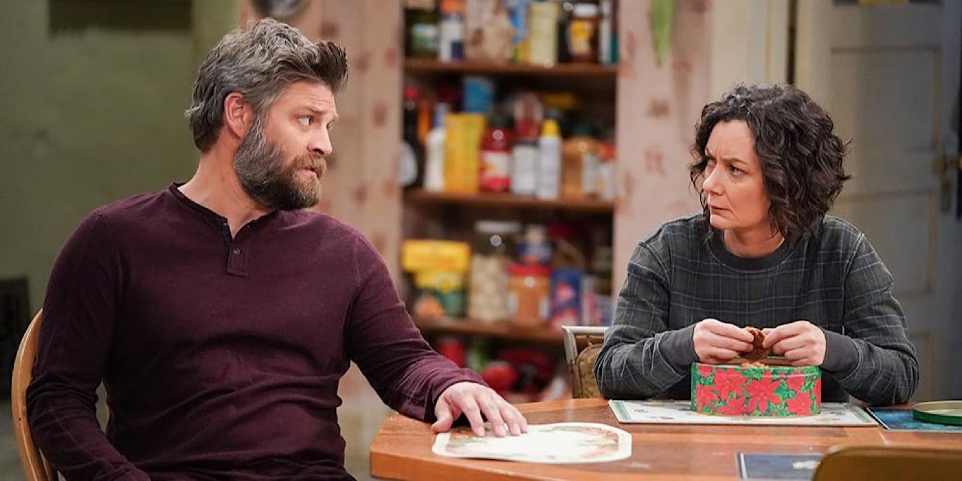 Ben and Darlene look at each other as Darlene holds a cookie.