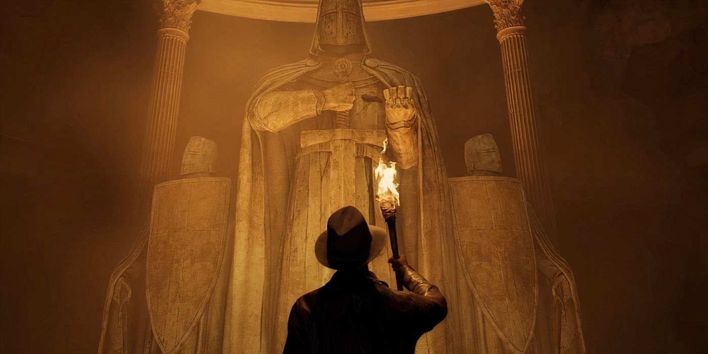 Indiana Jones mirando hacia arriba para ver tres estatuas gigantes con una antorcha en la mano