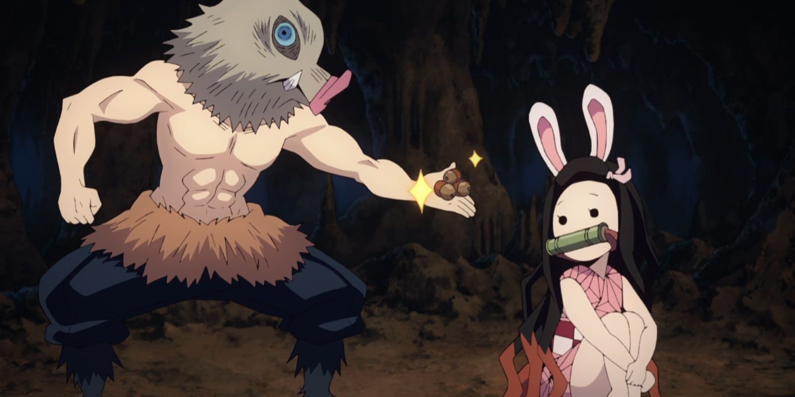 Inosuke offers acorns to Nezuko in a cave.