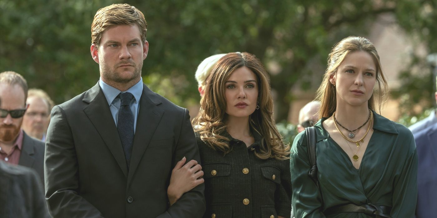 Cane, wearing a suit, with Peyton holding his arm next to Bree in Netflix TV show The Waterfront