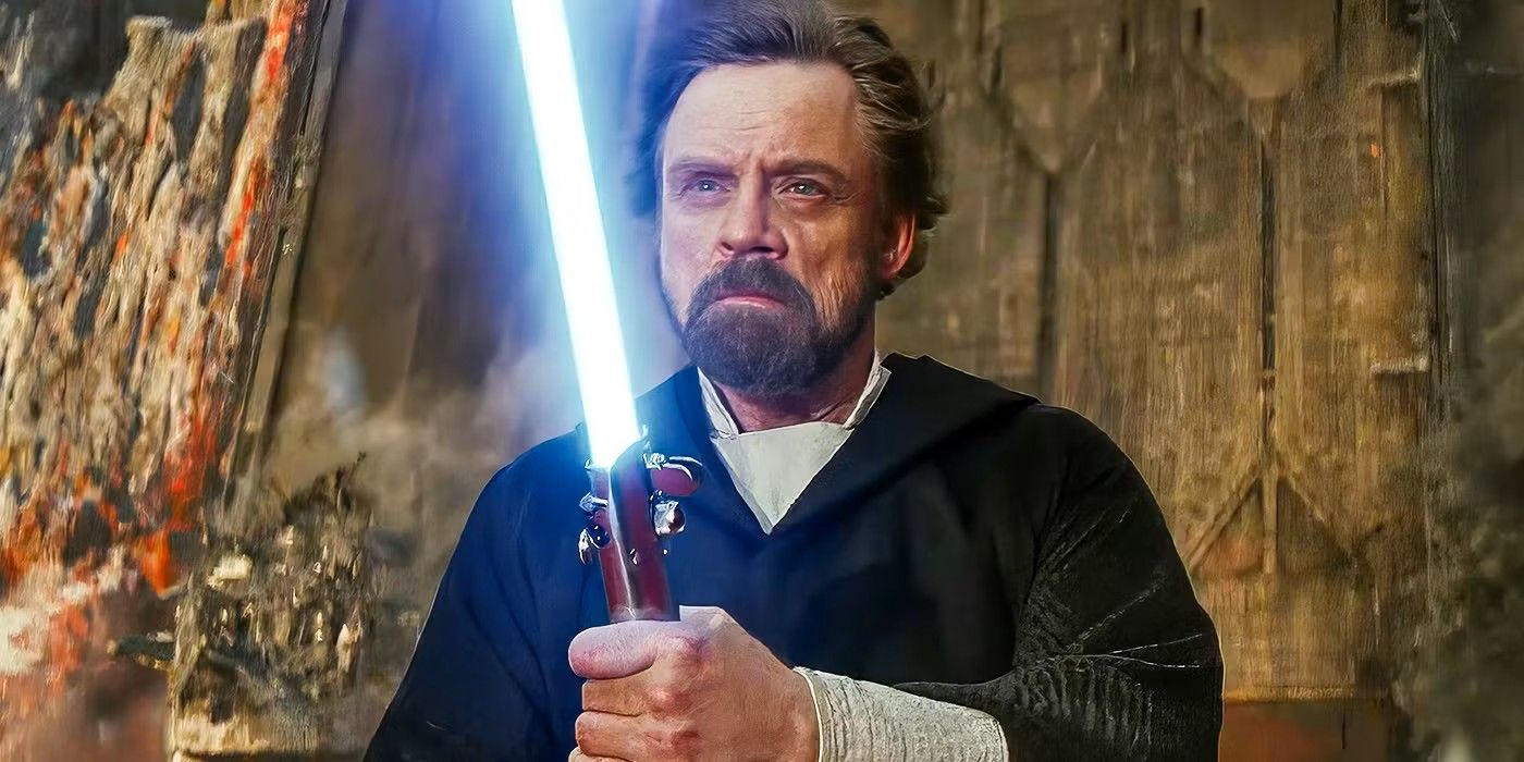 Luke Skywalker (Mark Hamill) in The Last Jedi holding his blue lightsaber.