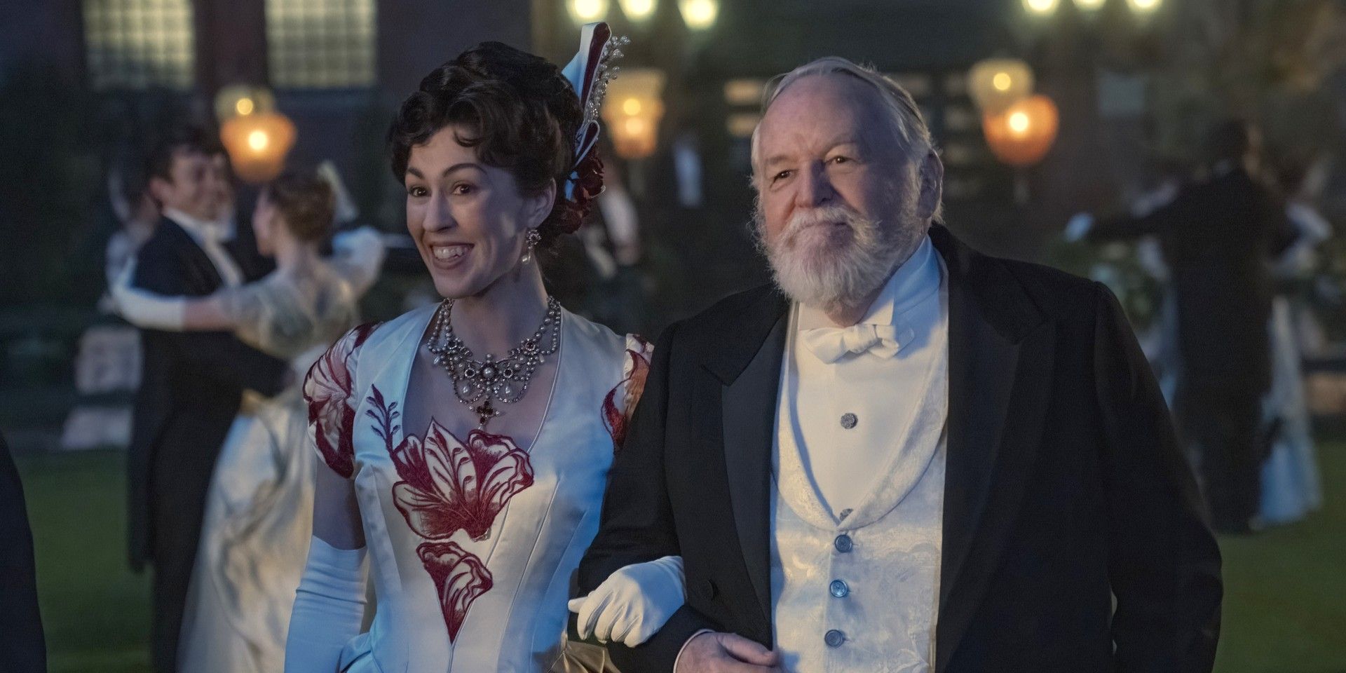 Enid (nee Turner) and Joshua Winterton standing and smiling in The Gilded Age Season 2.