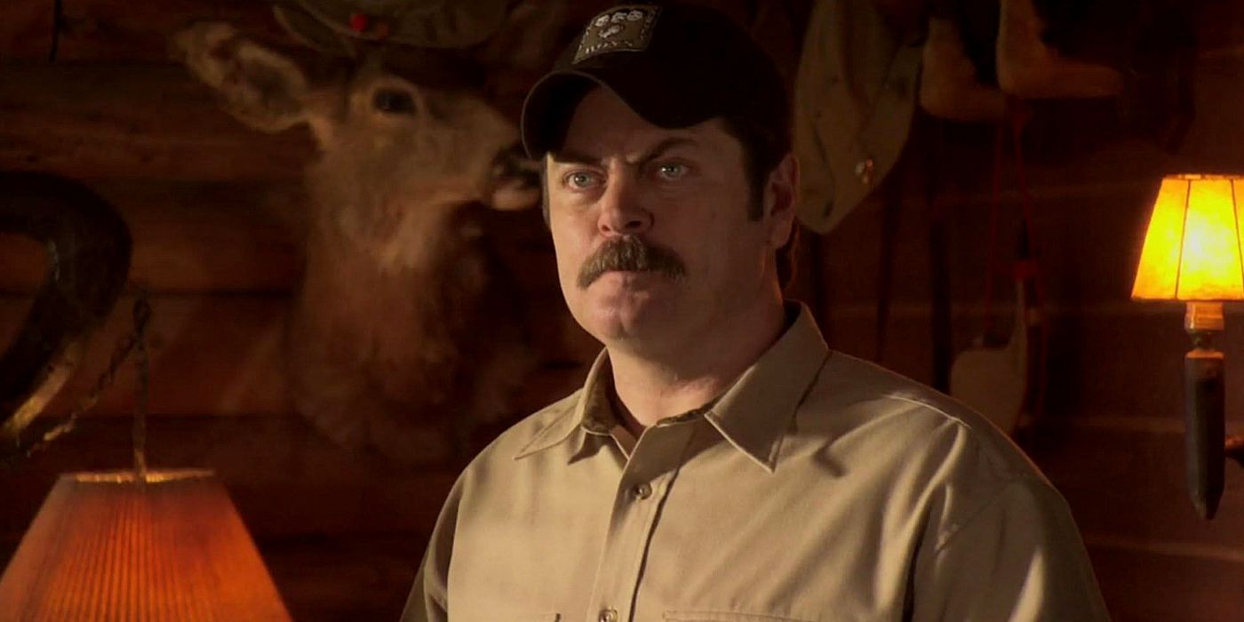 Ron is in his cabin, annoyed by Leslie Knope while on a hunting trip