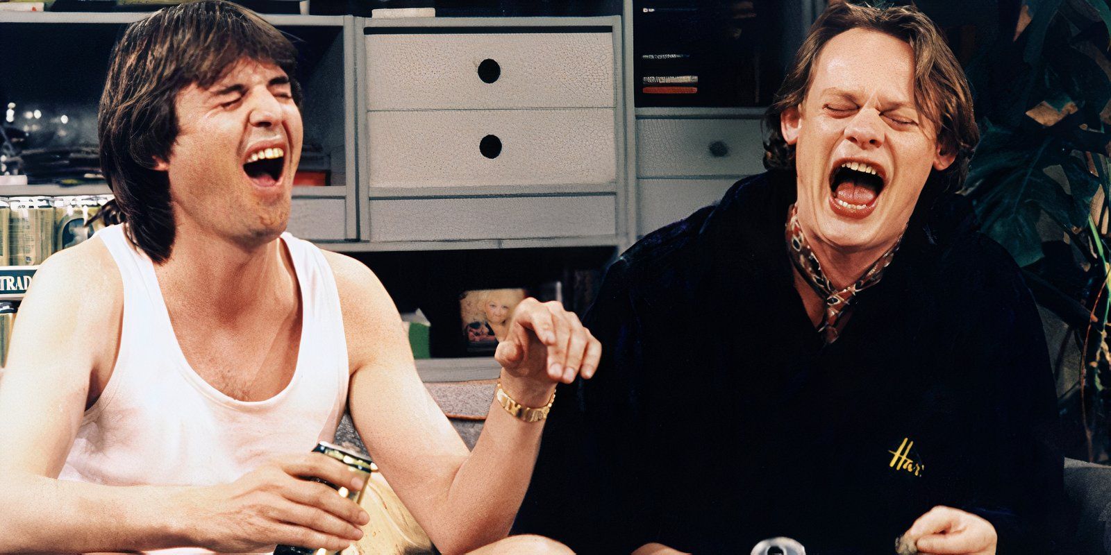 Two men howling with beers in their hands
