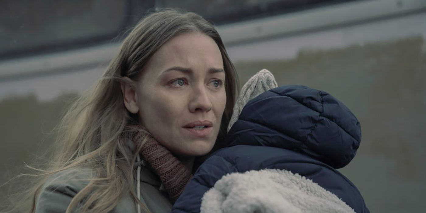 Serena clutching Noah tight with tears in her eyes outside in The Handmaid's Tale