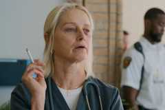 Dana holding a cigarette in The Pitt