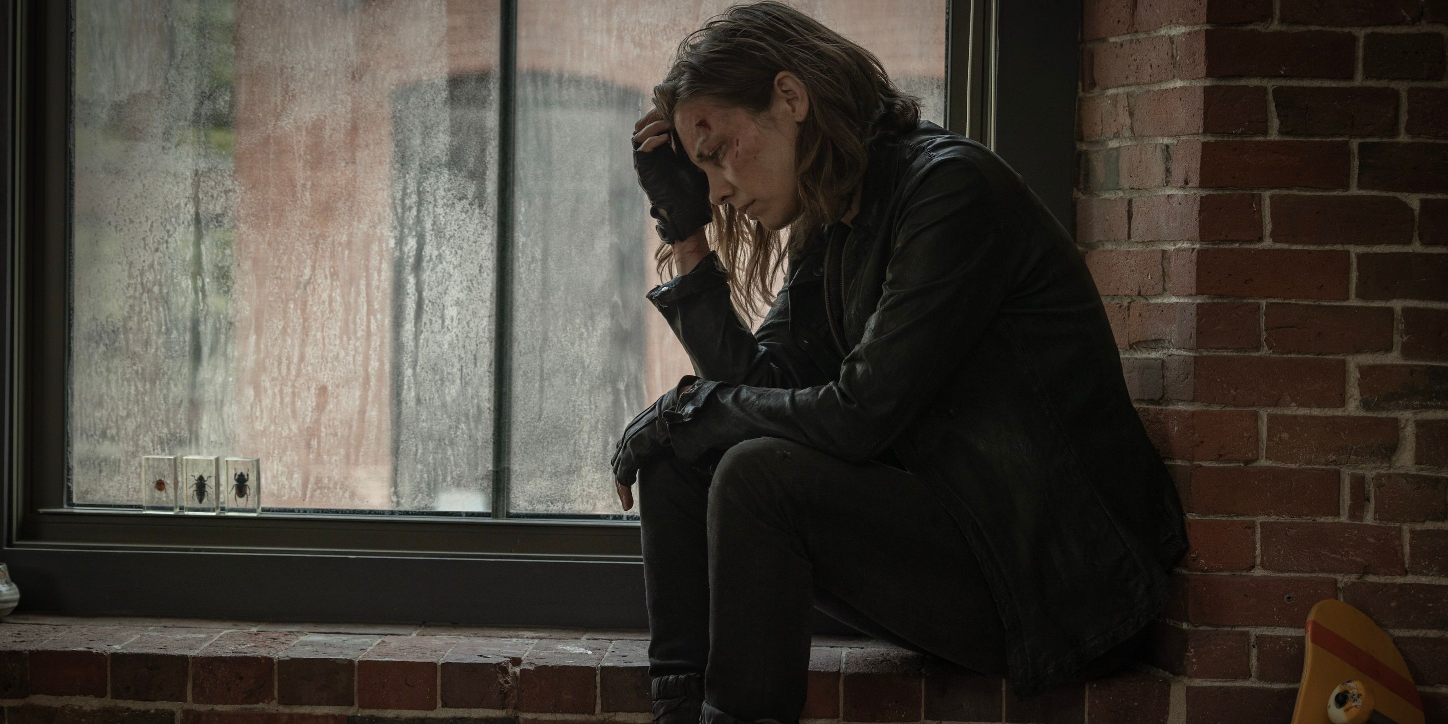 Maggie Rhee sitting by a window on The Walking Dead: Dead City