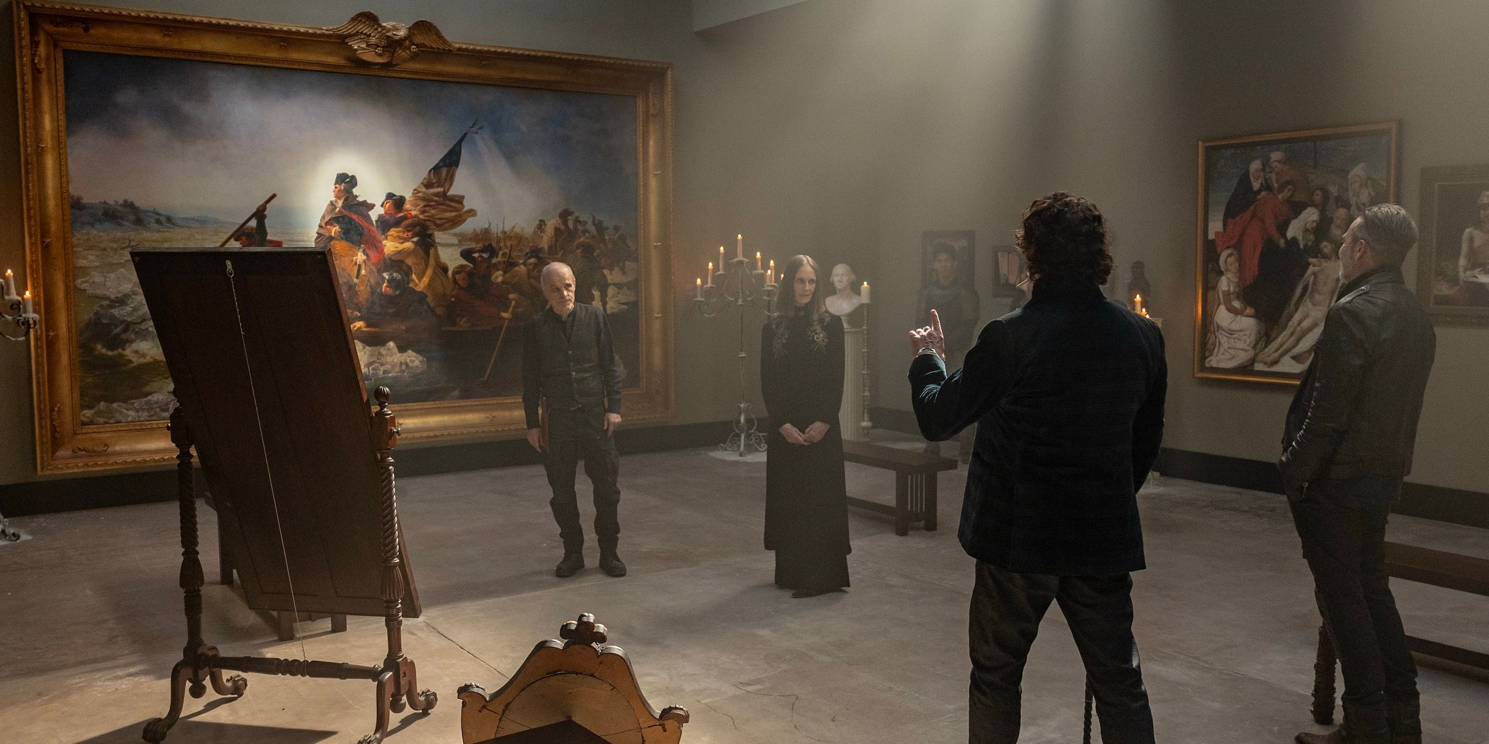 Bruegel (Kim Coates) showing the Croat, the Dama and Negan the "Washington Crossing the Delaware" painting on The Walking Dead: Dead City