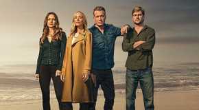 The Waterfront cast stands on a waterfront.