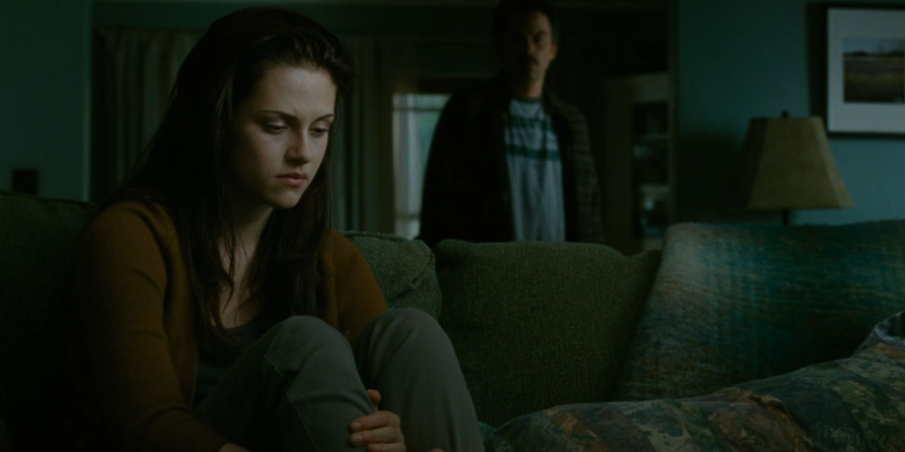 Bella looks sad while Charlie looks at her in Twilight New Moon