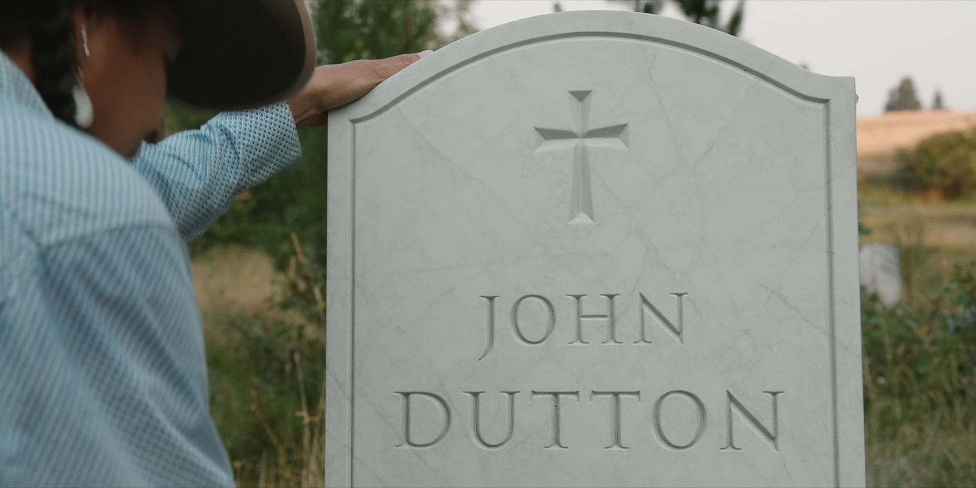 Mo cleans and resets John Dutton's gravestone in Yellowstone Season 5