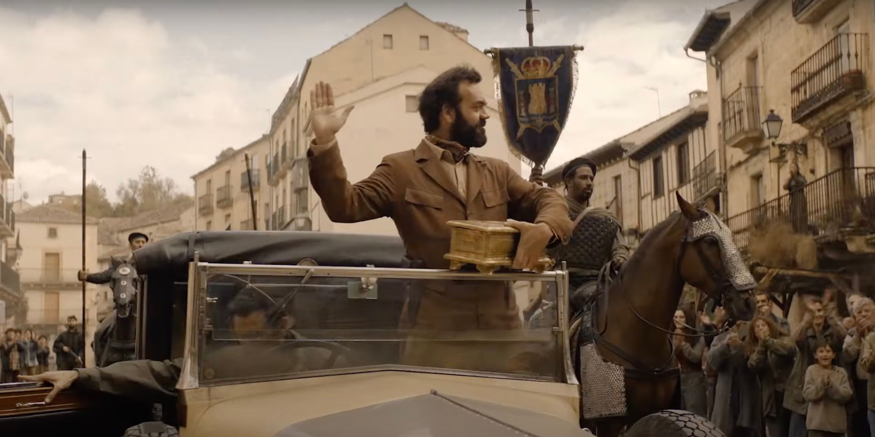 The "King" of Spain waving to villagers in a car on The Walking Dead: Daryl Dixon