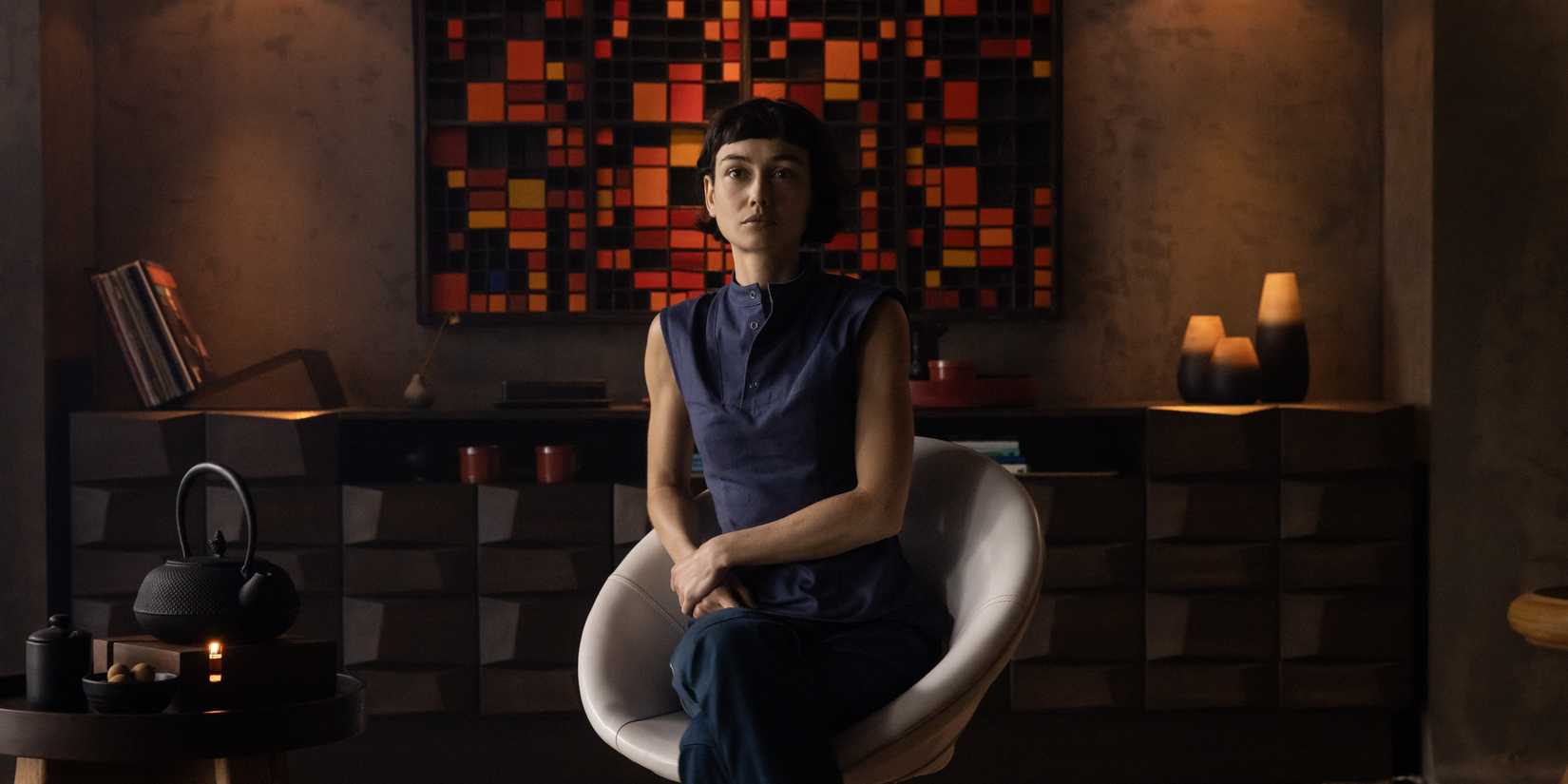 Wendy sits on a chair in an office in Alien Earth