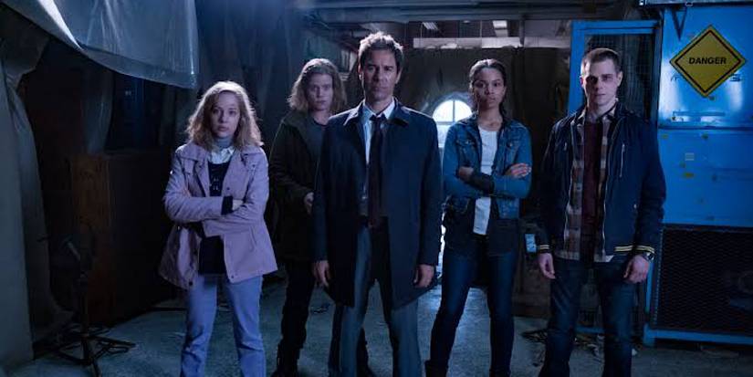 The five travelers stand together