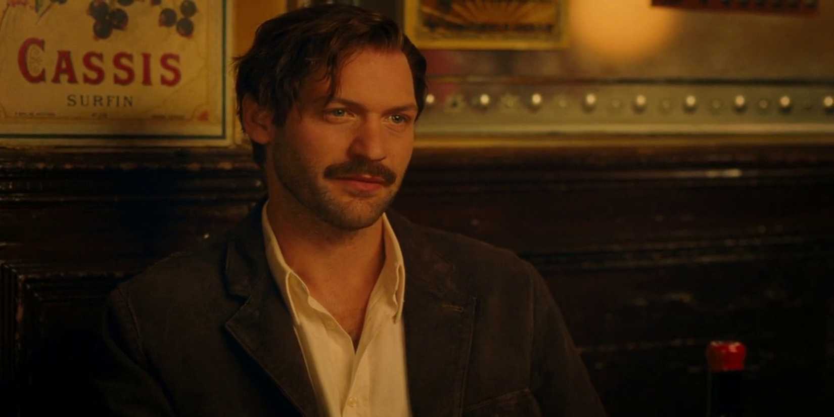 Hemingway sits in a bar at midnight in Paris.