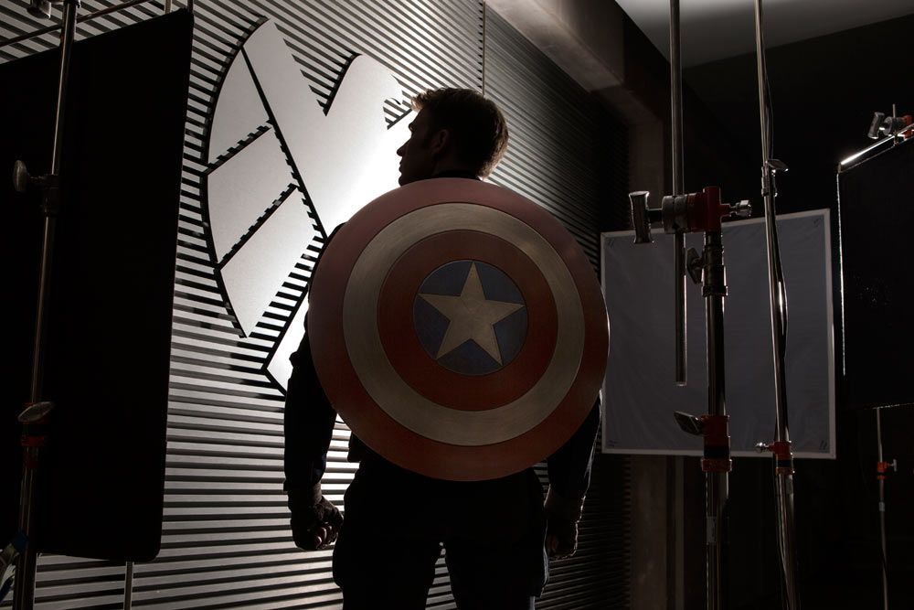 Captain America (Chris Evans) looking at a SHIELD logo on the wall in Captain America: Winter Soldier