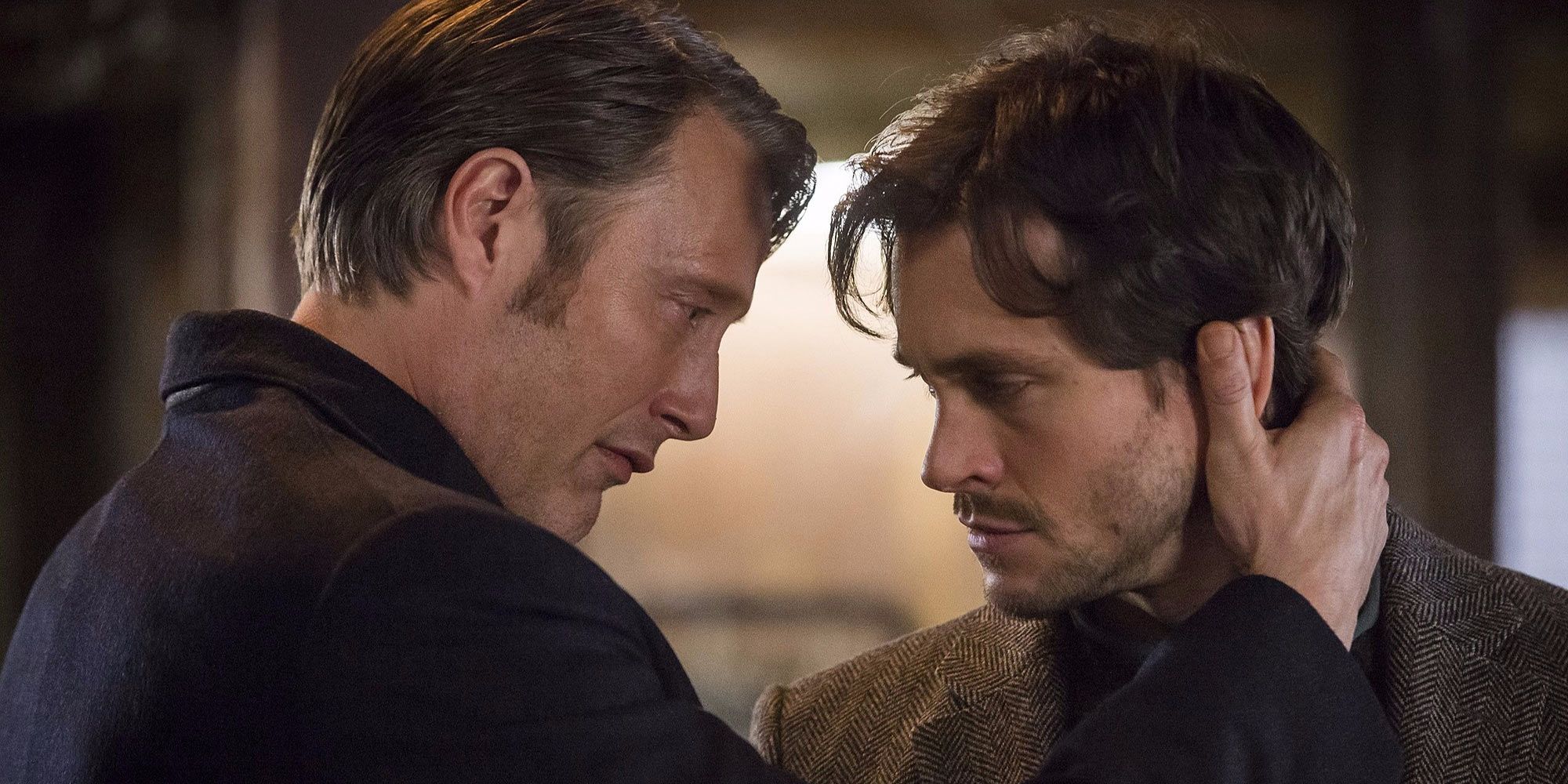 Mads Mikkelsen's Hannibal Lecter grabs Hugh Dancy's Will Graham by the neck in Hannibal.