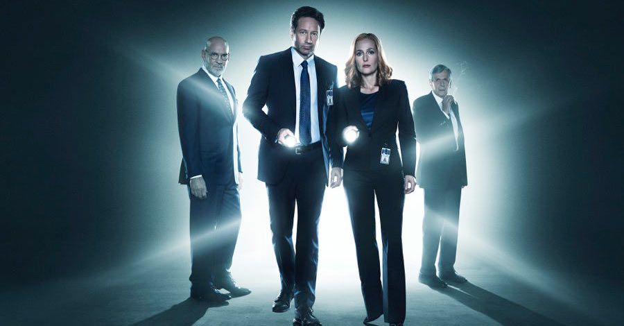 Mulder and Scully holding flashlights and flanked by Skinner and CSM in The X-Files revival